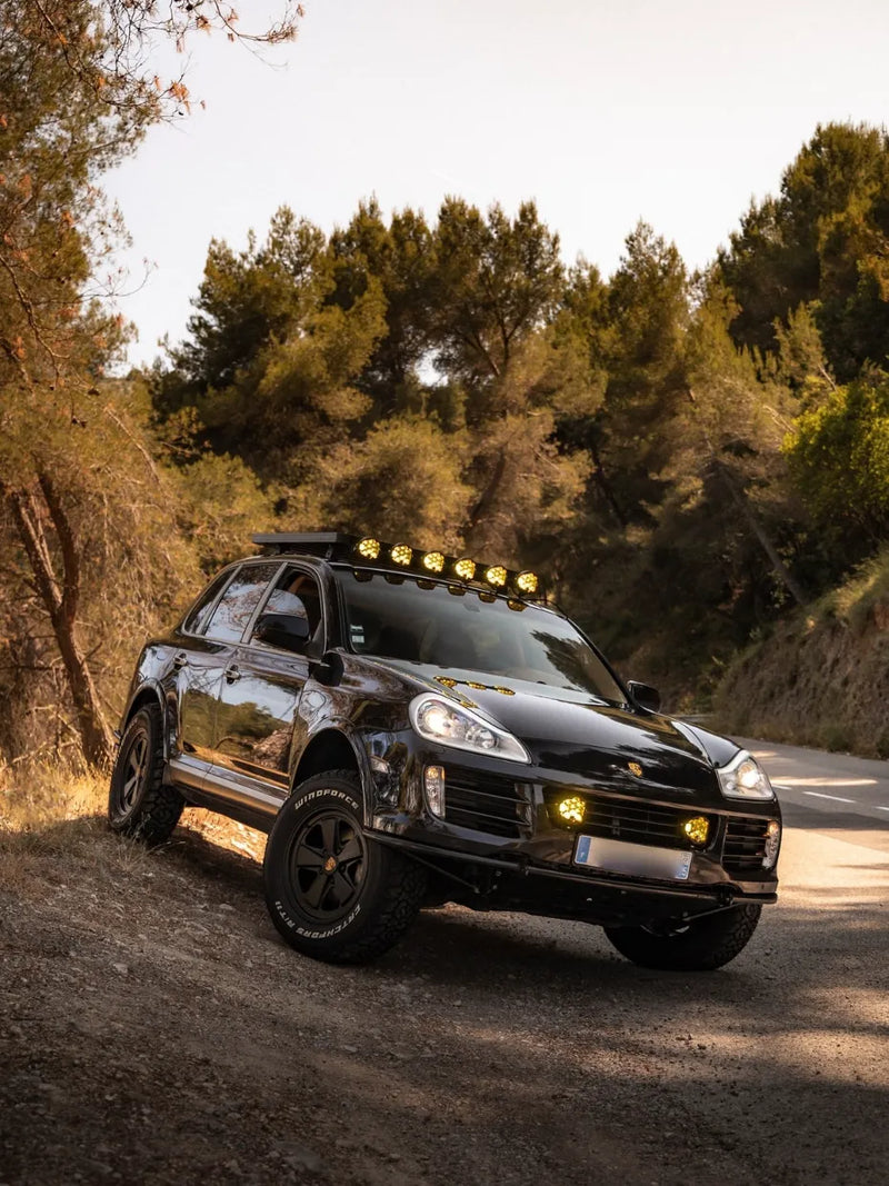 Porsche Cayenne overland build by Rise Offroad Monaco featuring Akioverland Classic Fuchs forged wheels on forest trail