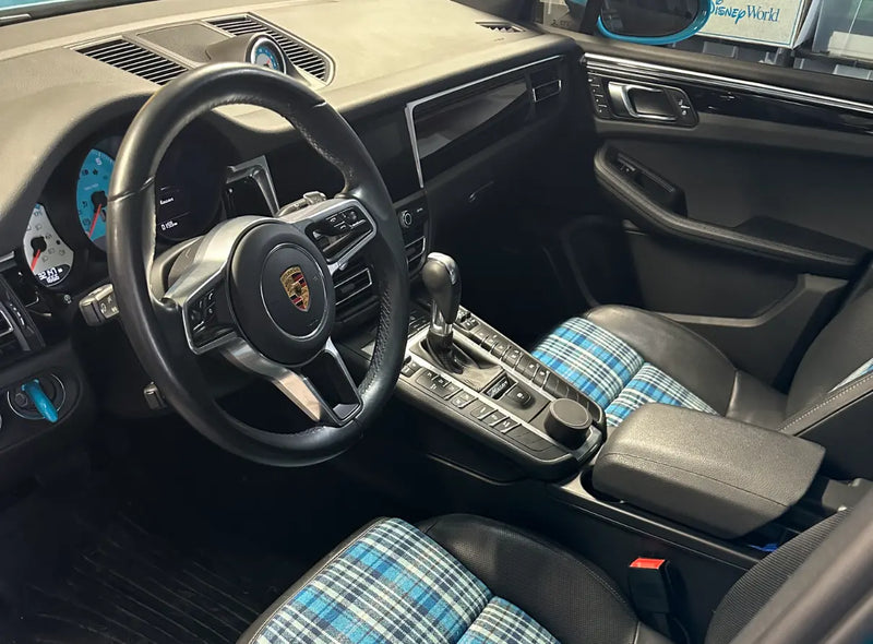 Wide interior view of 2021 Porsche Macan Sully showing Karo Madras plaid seats by Relicate DuraMend, custom blue gauge faces and PDK shifter — Ohio build detail