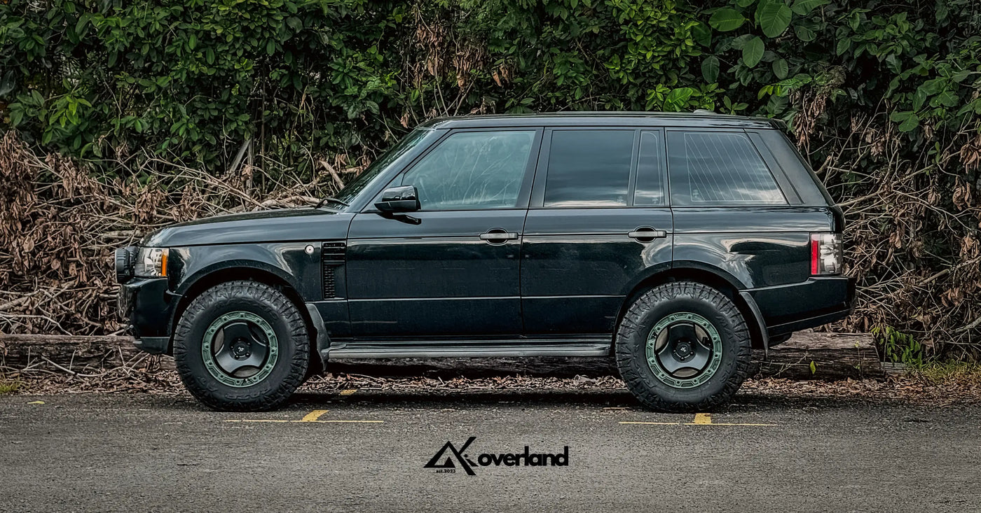 Side profile of lifted Range Rover L322 fitted with 5x120 trispoke forged off-road wheels and rugged tire setup.