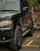 Front quarter angle of Range Rover L322 overland build with 5x120 trispoke forged wheels and lifted stance.